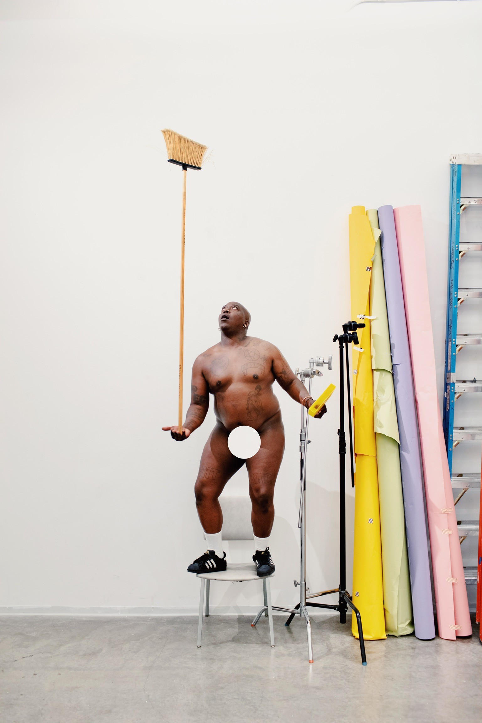 Brontez balancing a broom stick - the subject of a series by photographer Dominique HILDEBRAND entitled "Ego Sculptures".