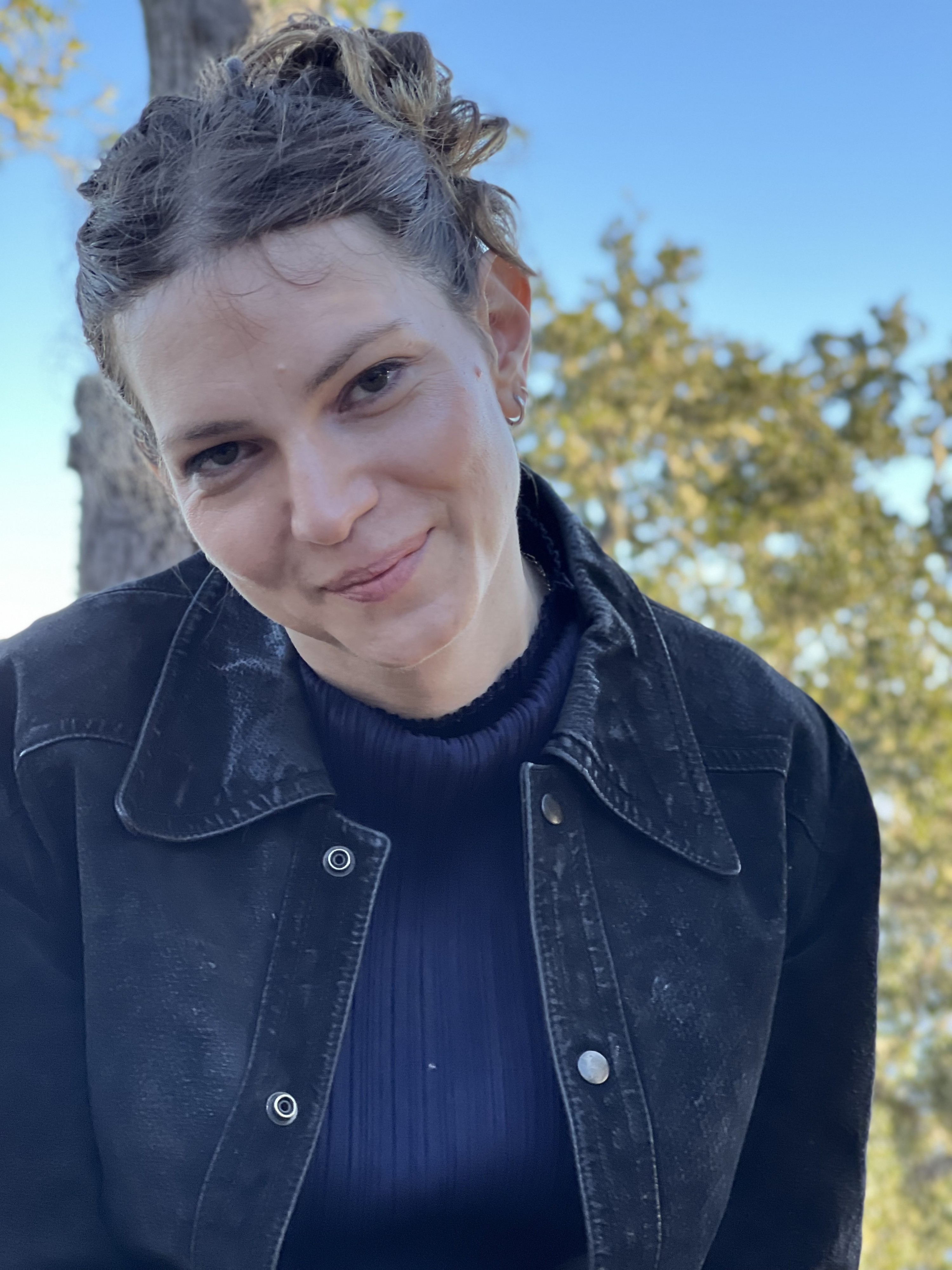hannah, a white woman in her 30s smiles at the camera.