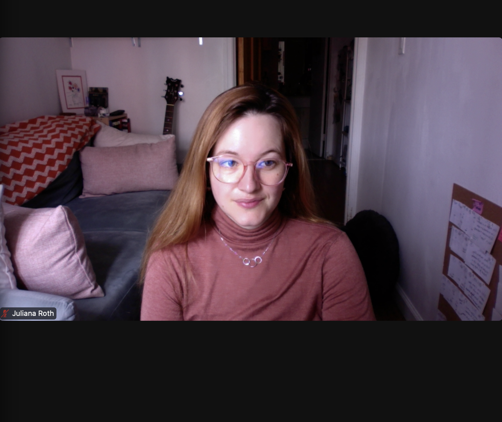 In this Zoom screenshot, Juliana Roth is wearing a turtleneck and glasses