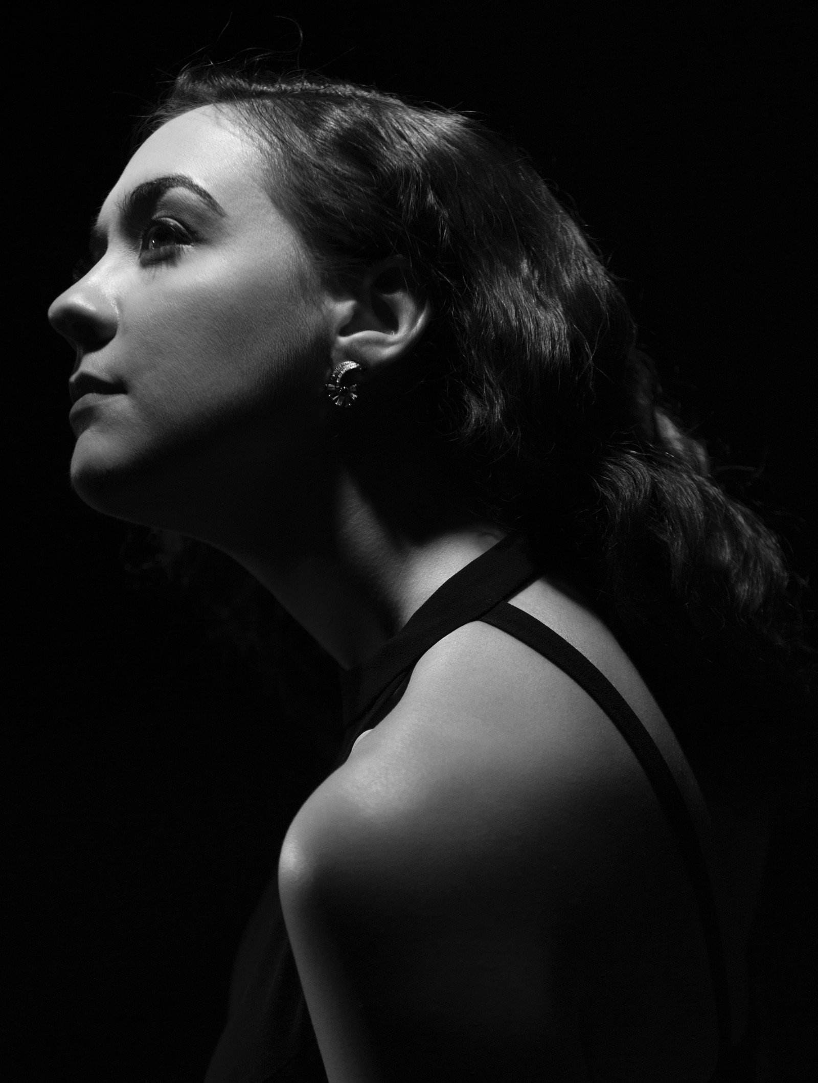 In this black and white portrait, Kathleen Granados is seen in profile, lit from above.