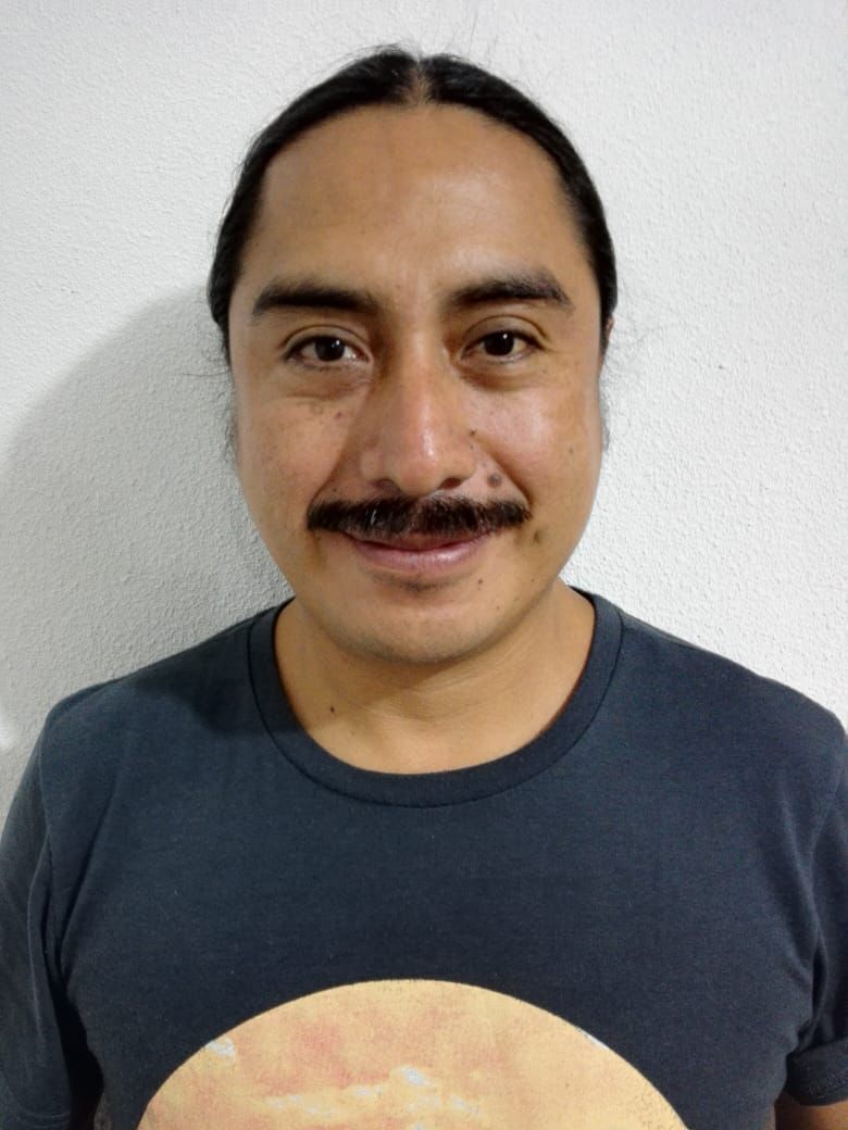 Photograph of Reyes Josué Morales against a white backdrop.