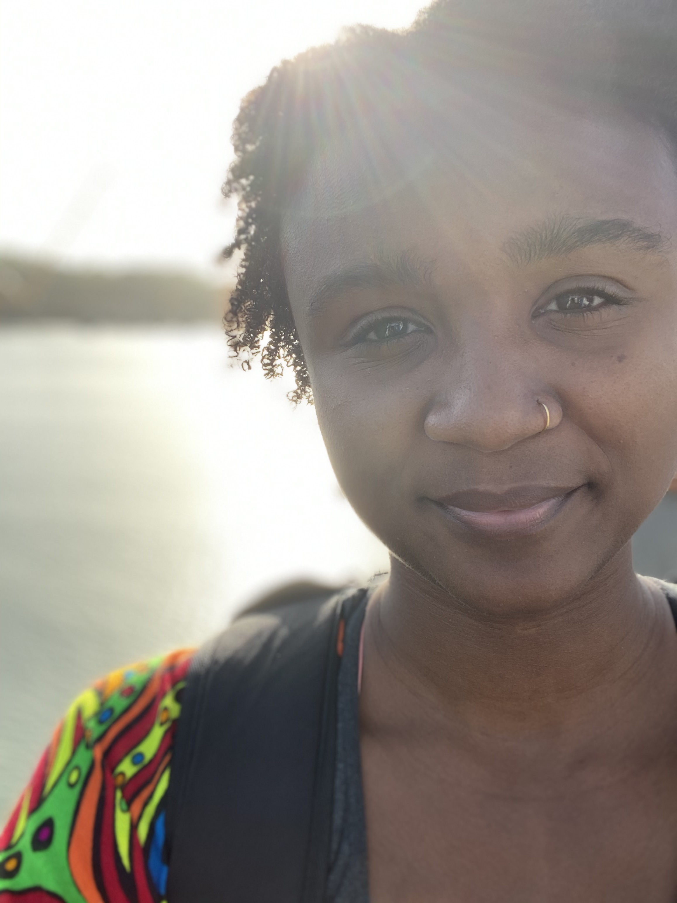Shyanne Figueroa Bennett is facing the camera and smiling with the sun behind her
