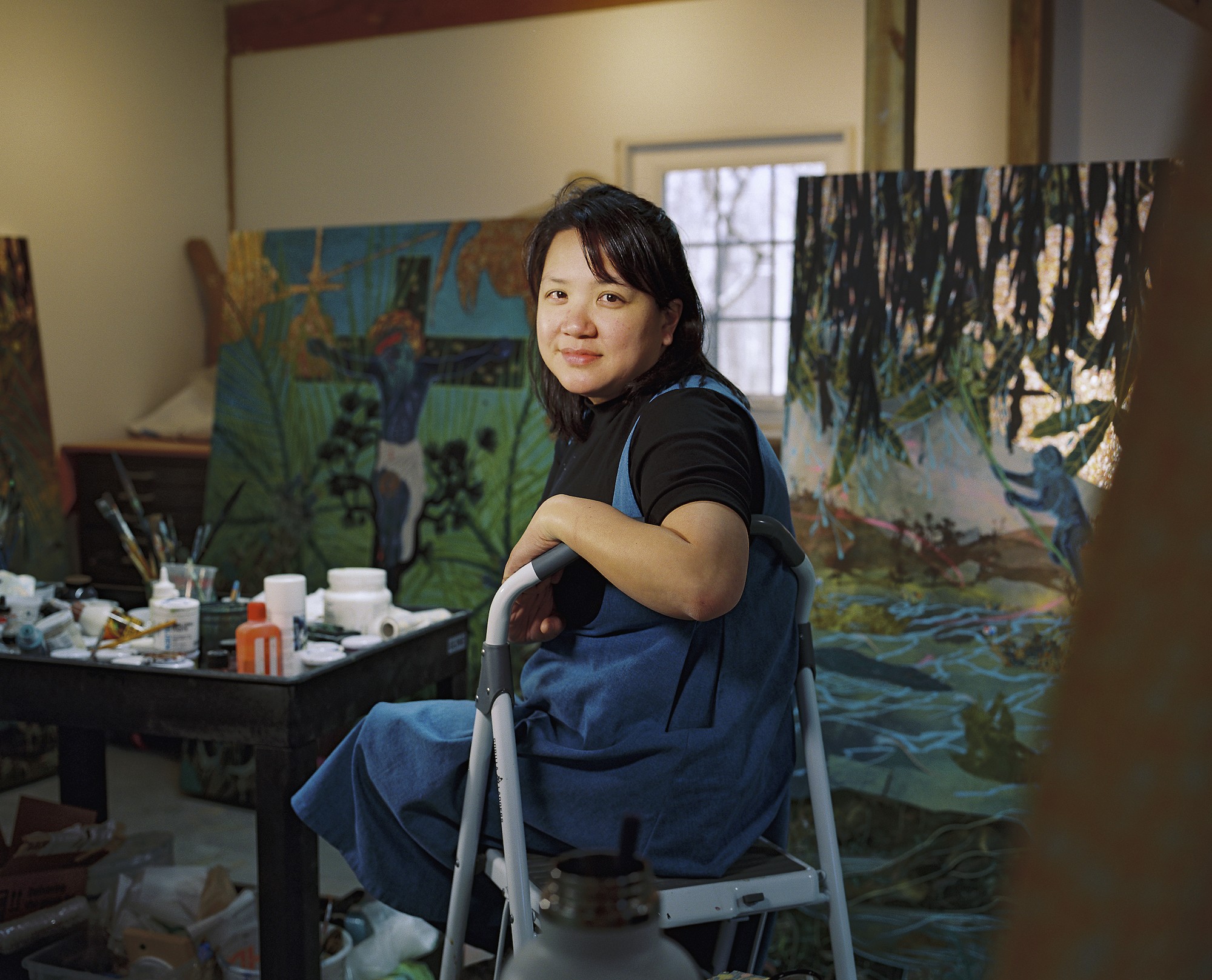 A portrait of artist Tammy Nguyen in her studio.